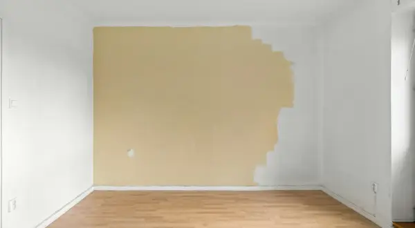 Ściana w połowie pomalowana na żółto, jakby ktoś zastanawiał się, czy lepsza będzie farba ceramiczna czy lateksowa.
